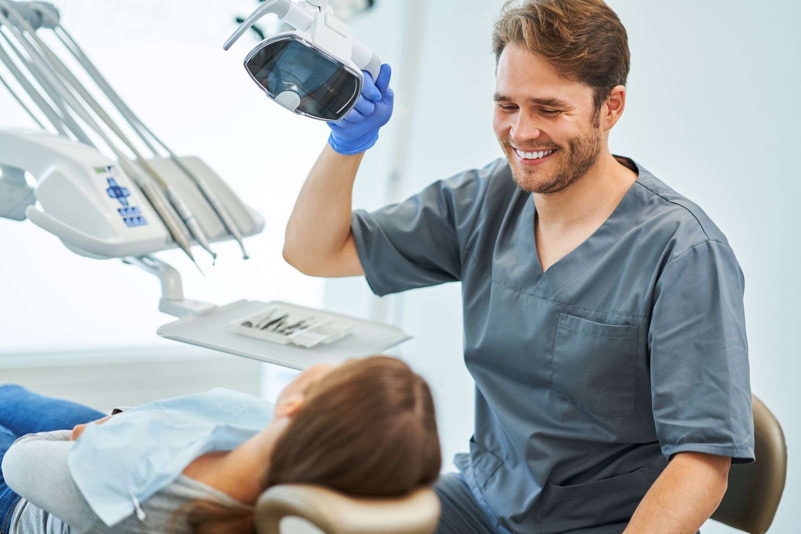 Dentist with patient in modern dental office - dental practice IT support