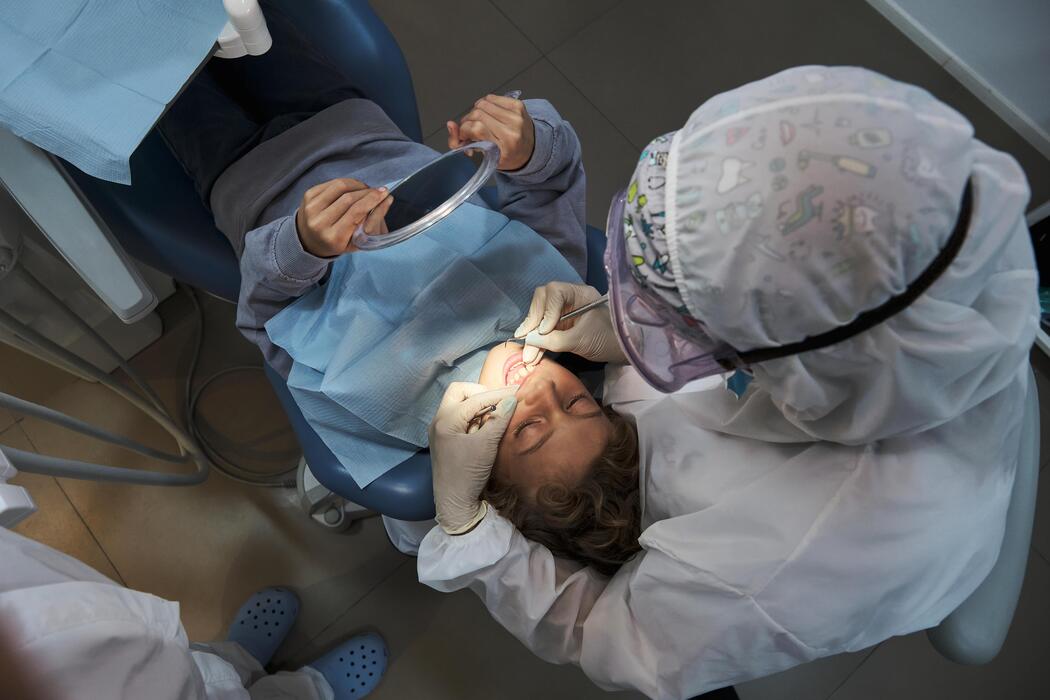 Mobile dental practice IT support Dentist examining a young patient’s teeth during a mobile dental visit