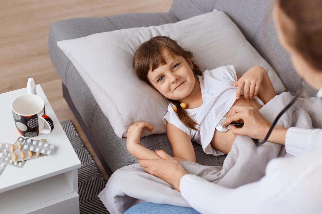 Home care nurse checking on a child during a pediatric home visit