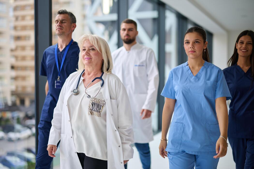 Interdisciplinary clinical care team walking through the corridor of an inpatient psychiatric hospital