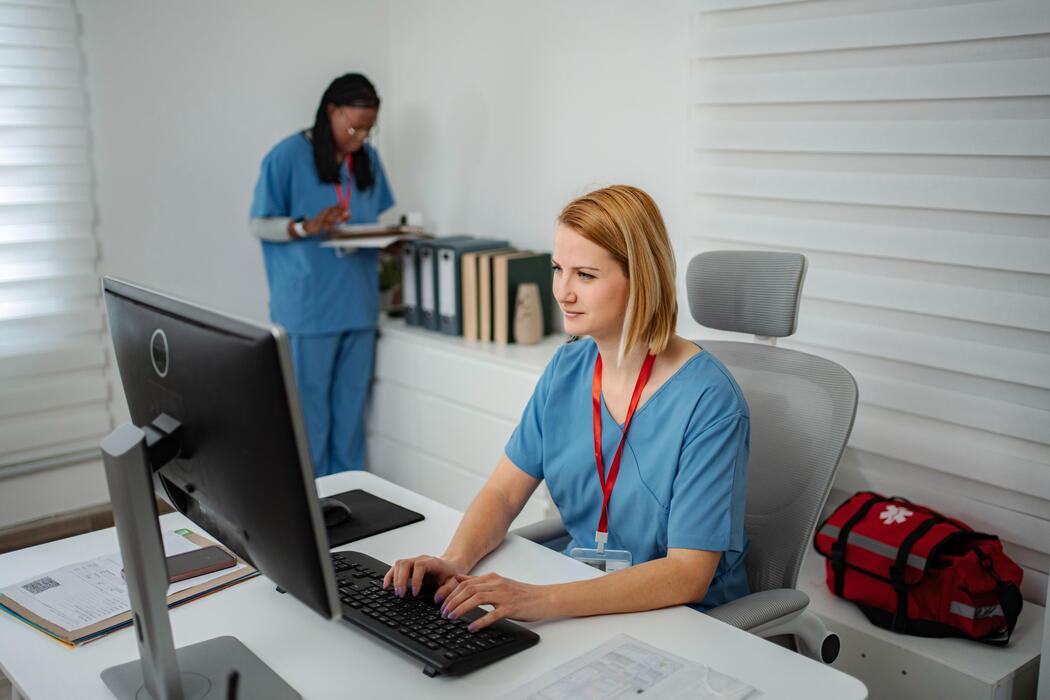 Records staff securely processing medical record requests on a computer at a release of information company