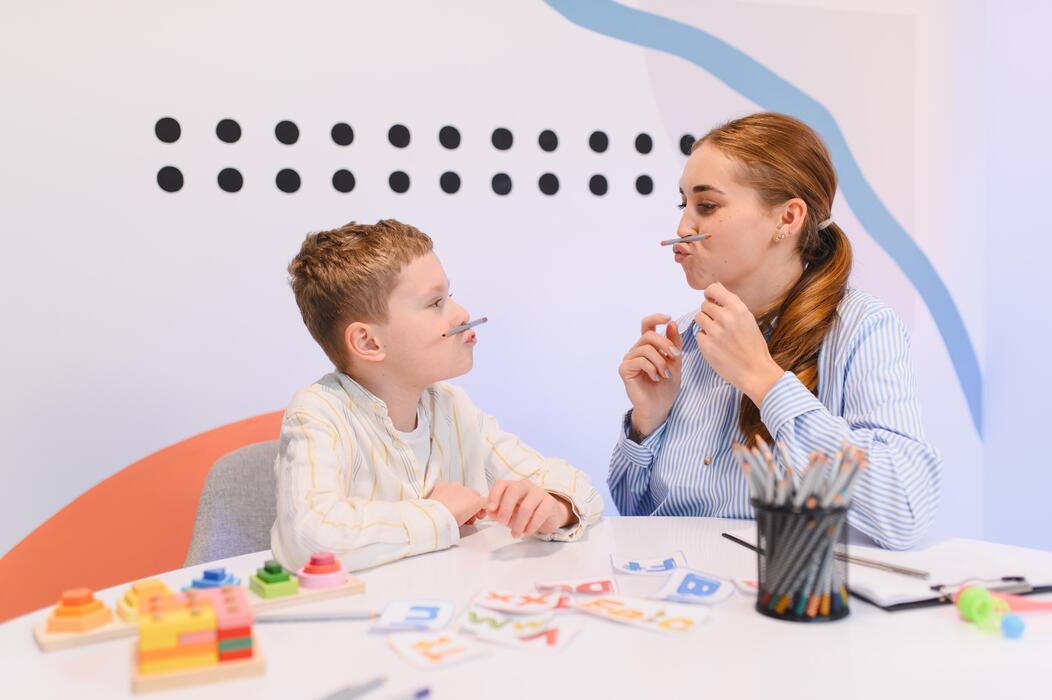 Speech Therapy Session With Child Child practicing speech therapy exercises with a speech-language pathologist