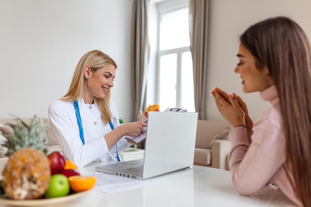 Sports nutritionist consulting with a client about a performance meal plan