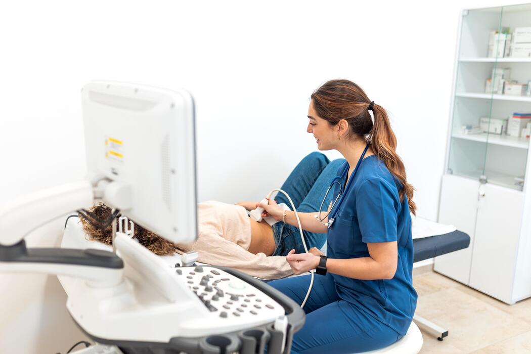 Sonographer performing a diagnostic ultrasound examination on a patient
