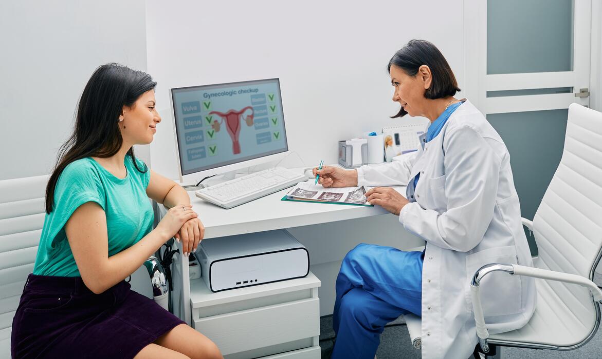 Gynecologist consulting a woman patient at a womens health clinic